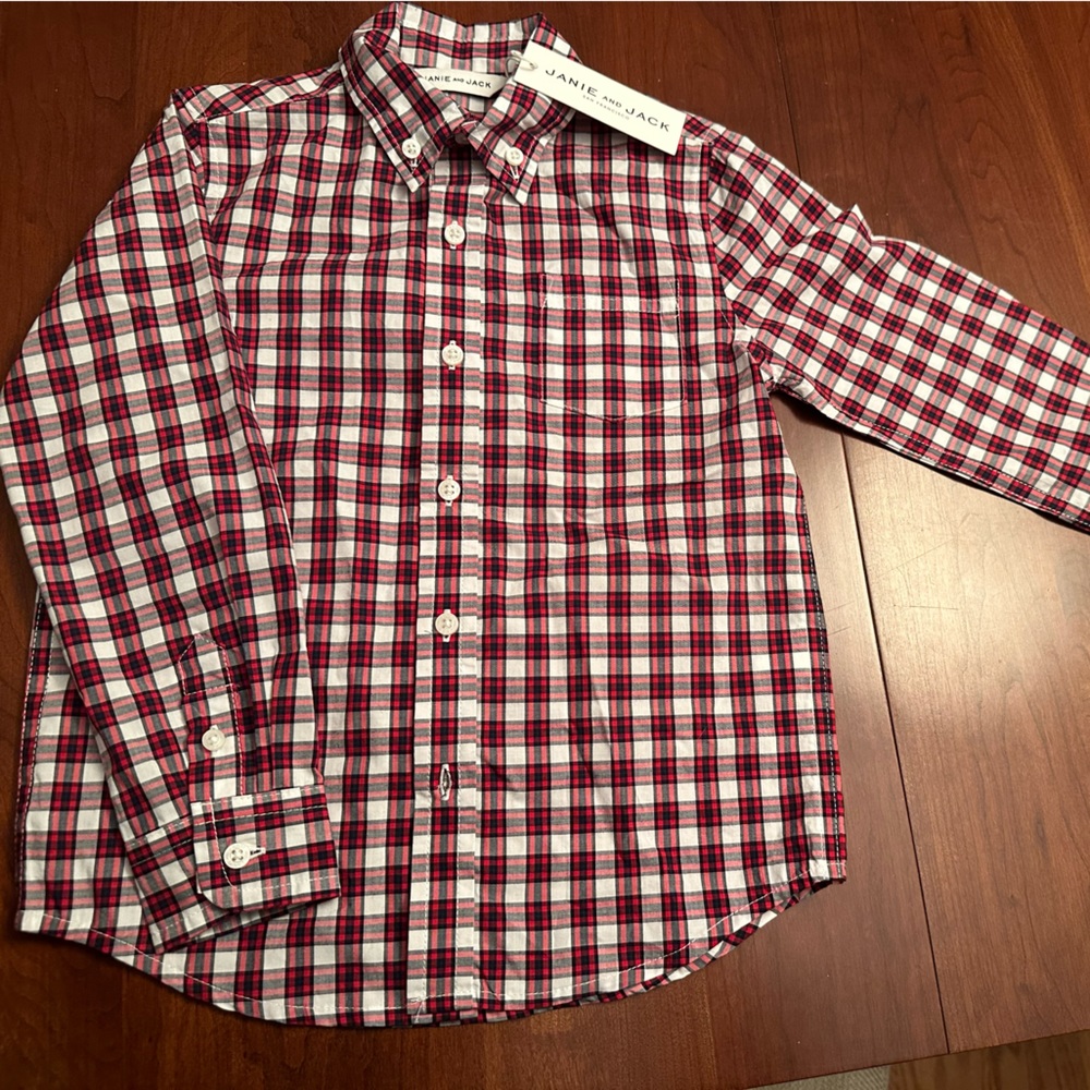 Get holiday ready with this adorable red and black plaid button down shirt.